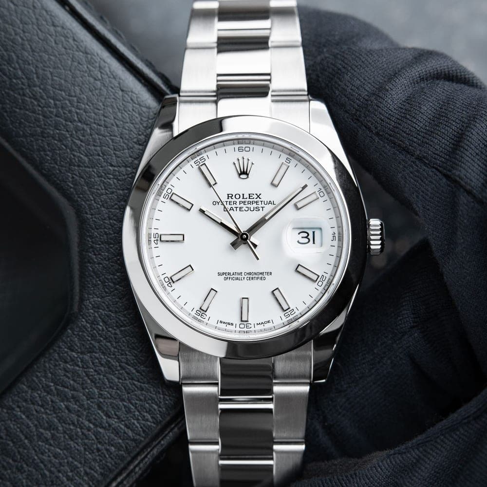 The white-dial Rolex Datejust behind the build